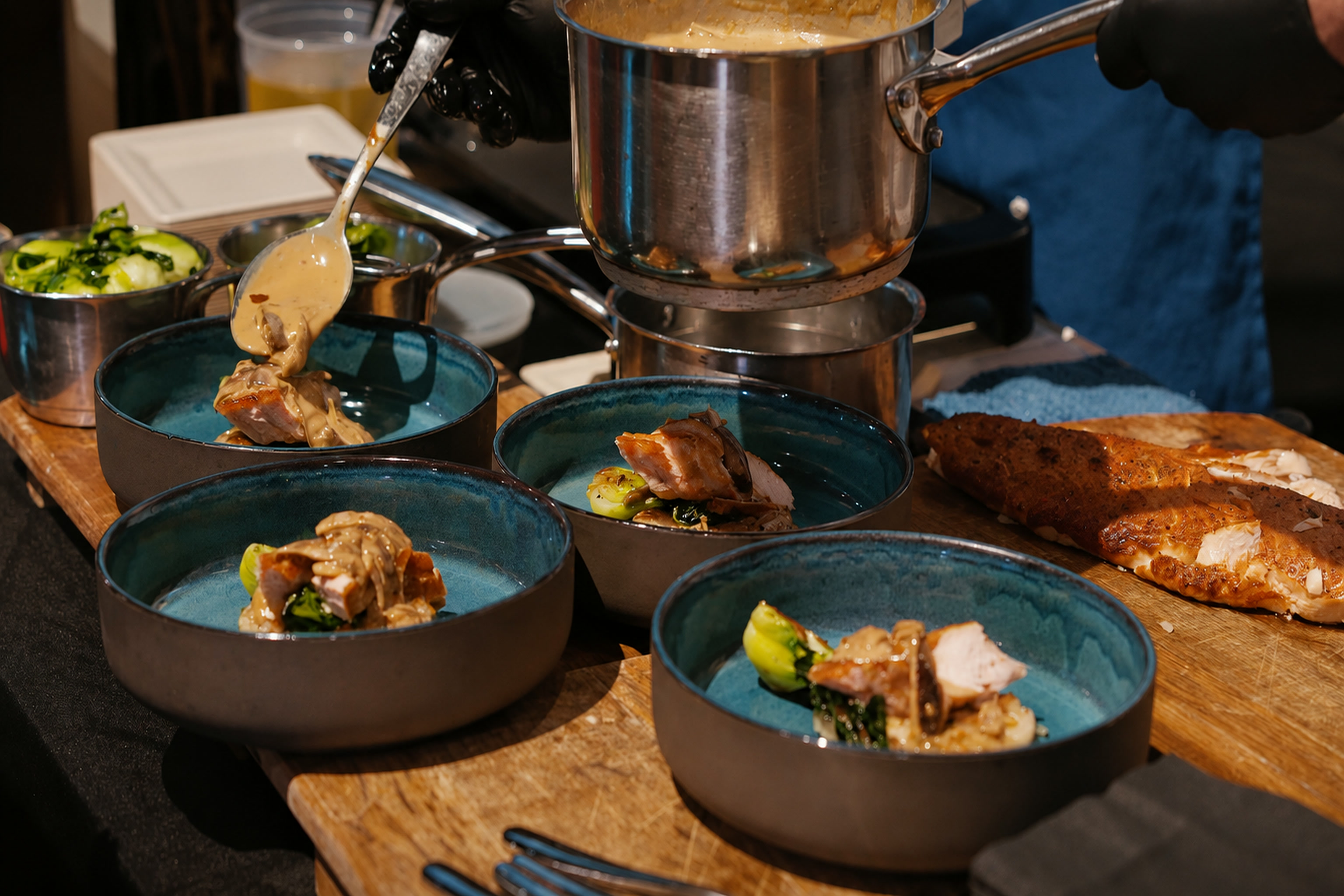 A chef plating dishes for guests