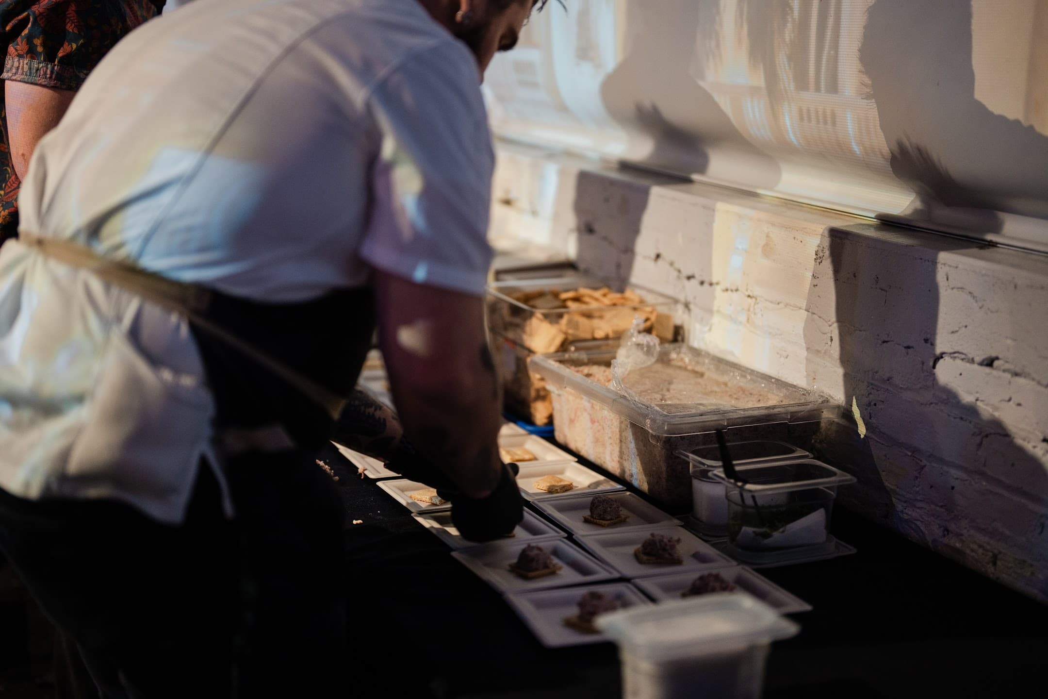 A culinary partner prepares tasting portions onsite